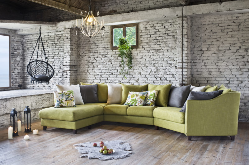 Green sofa with furnished accessories.