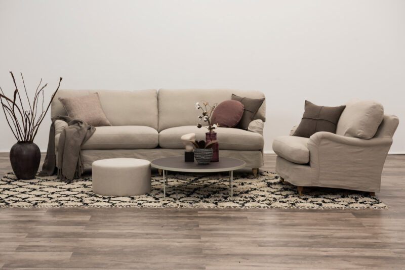 ORUST sofa and armchair furnished with accessories.